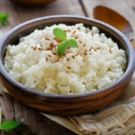 A bowl of thick, creamy rice pudding with a sprinkle of cinnamon.